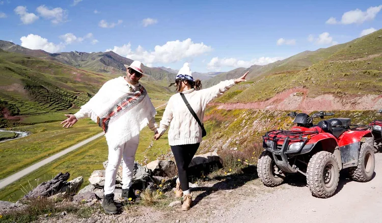 Couple of tourists taking the Rainbow Mountain tour on an ATV
