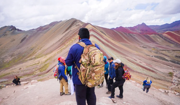 Visitor observing the rainbow mountain – Vinicunca